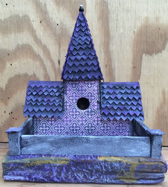 Back view of the purple Tower house, you can see the wall that I added. I added sand to grey paint and then distressed it with some white and black paint.