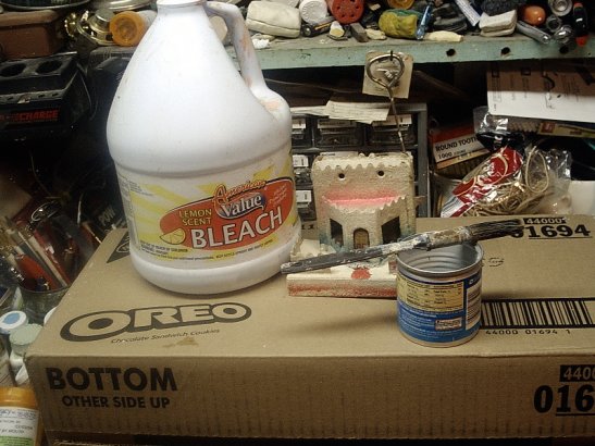 Cleaning cardboard Christmas village houses with 
bleach