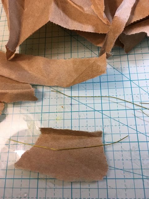 Tear the paper in strips to wrap around the wire.