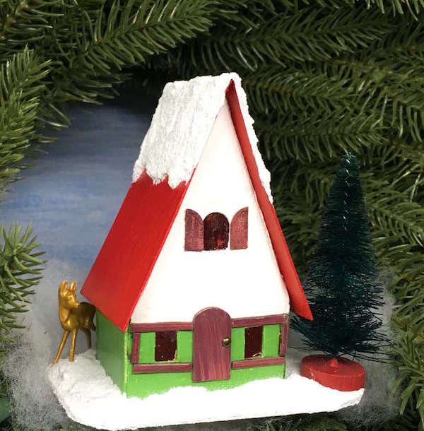 Swiss Chalet Christmas Putz paper house on a wreath with deer bottle brush tree.jpg