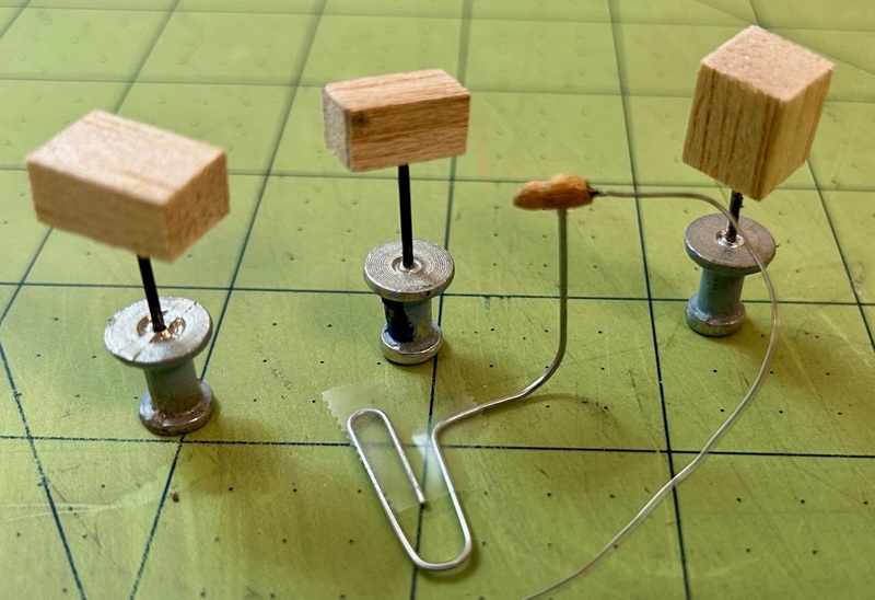 closeup balsa presents carved wood and wire mouse.jpg